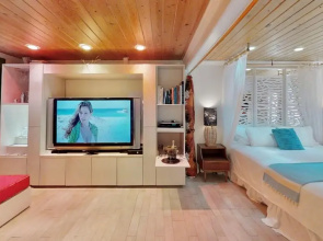 Tropical Beach Bungalow by Teeming Vacation Rentals