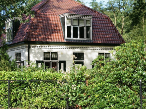 Characteristic house with a garden, surrounded by forest