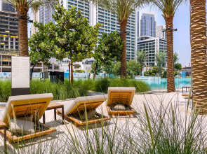 Апартаменты Сozy 1BR at Vida Residences Creek Beach