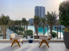 Апартаменты Сozy 1BR at Vida Residences Creek Beach