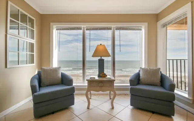 Coast View Condo Featuring Large Windows Overlooking the Beach by RedAwning