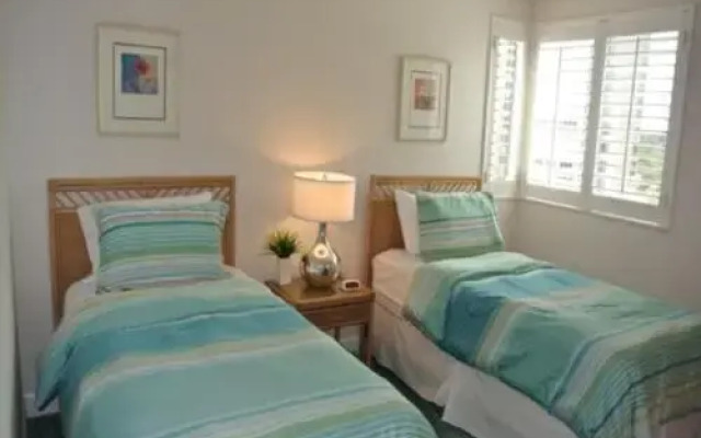 Deluxe Beachfront Condo Located in Prestigious Resort with Pool and Hot Tub by RedAwning