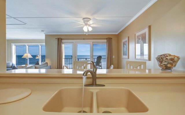 Coast View Condo Featuring Large Windows Overlooking the Beach by RedAwning