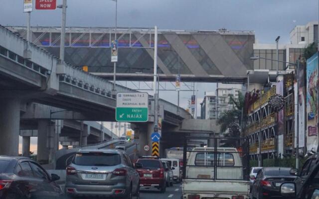 Palm Tree Condos across NAIA3 by Beth