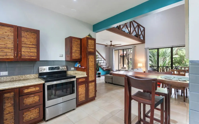 Modern Island-Themed Condo with Floor-to-Ceiling Windows & Garden and Pool Views Within Walking Distance of the Beach