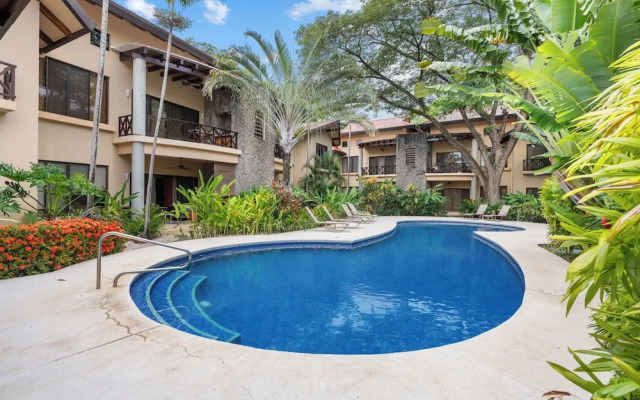 Modern Island-Themed Condo with Floor-to-Ceiling Windows & Garden and Pool Views Within Walking Distance of the Beach