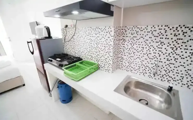 Tidy and Compact Studio at Puncak Dharmahusada Apartment By Travelio