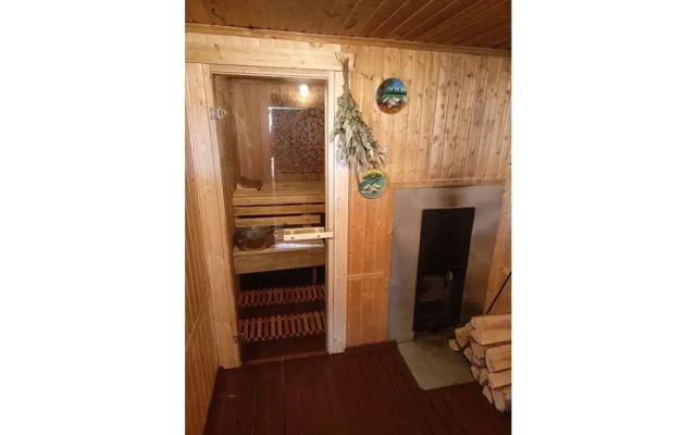 A-frame house with a bath tub and a wood-burning sauna