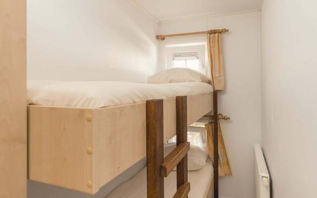 Comfy chalet with a dishwasher, directly on a pond