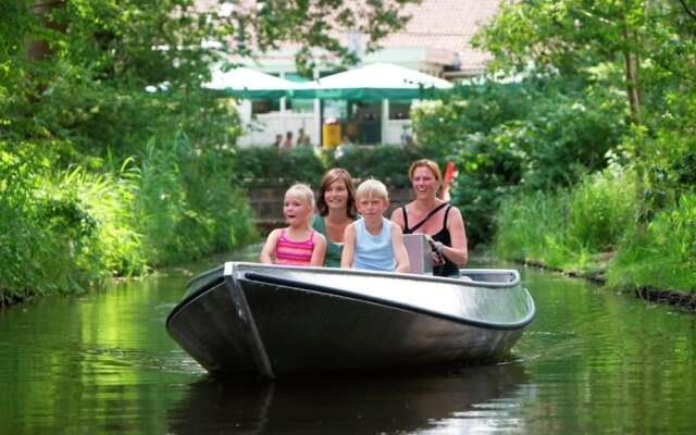 Comfy chalet with a dishwasher, directly on a pond