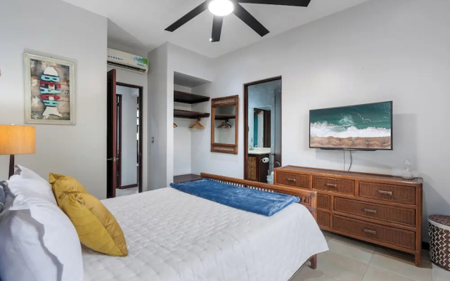 Modern Island-Themed Condo with Floor-to-Ceiling Windows & Garden and Pool Views Within Walking Distance of the Beach