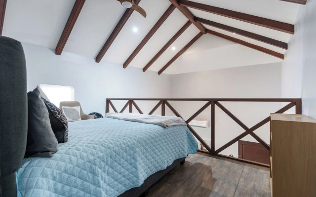 Modern Island-Themed Condo with Floor-to-Ceiling Windows & Garden and Pool Views Within Walking Distance of the Beach