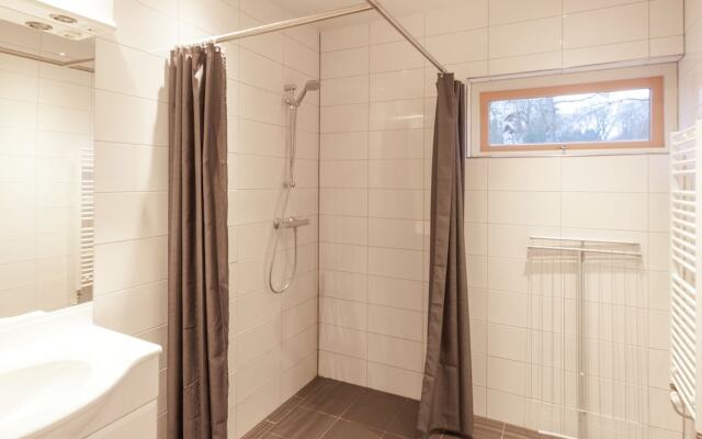 Cozy decorated house with fireplace, surrounded by forest