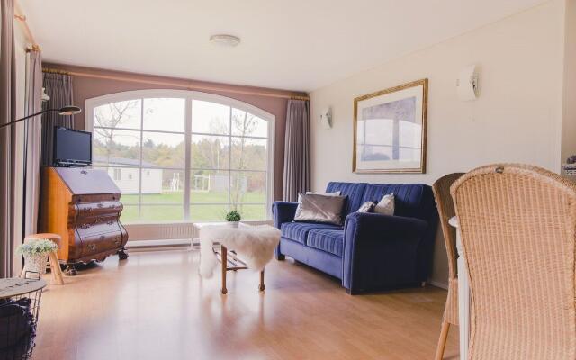 Comfy chalet with a dishwasher, directly on a pond