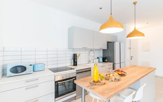Sunlit Urban Escape with Balcony by Sea N Rent