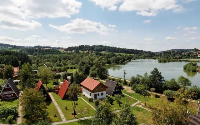 Wooden Chalet with Terrace near Swimming Lake