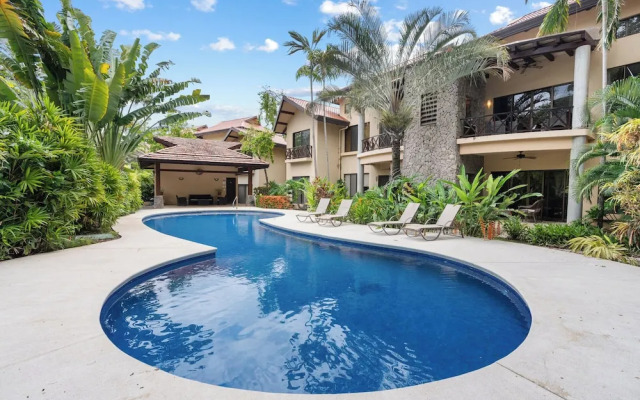 Modern Island-Themed Condo with Floor-to-Ceiling Windows & Garden and Pool Views Within Walking Distance of the Beach