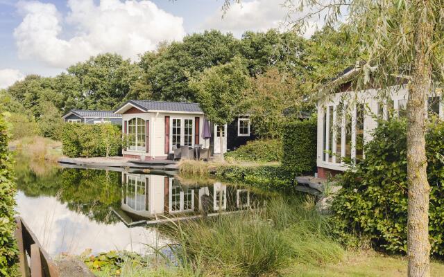 Comfy chalet with a dishwasher, directly on a pond