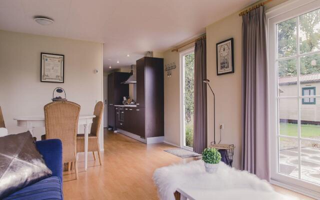 Comfy chalet with a dishwasher, directly on a pond