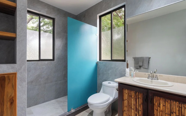 Modern Island-Themed Condo with Floor-to-Ceiling Windows & Garden and Pool Views Within Walking Distance of the Beach