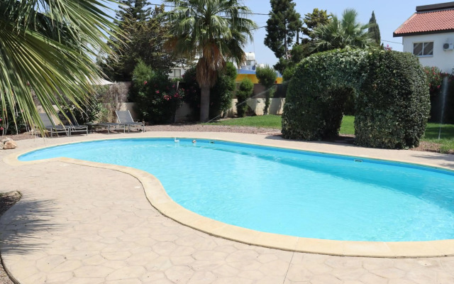 Mediterranean poolside garden cottage