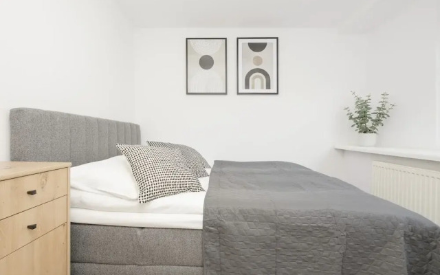 Grey Apartment Śródmieście by Renters