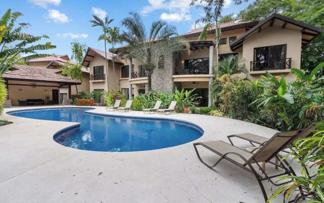 Modern Island-Themed Condo with Floor-to-Ceiling Windows & Garden and Pool Views Within Walking Distance of the Beach