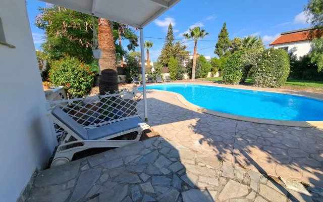 Mediterranean poolside garden cottage