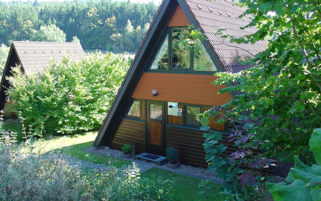 Detached, wooden bungalow with a terrace, in a wooded area