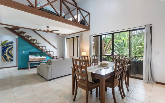 Modern Island-Themed Condo with Floor-to-Ceiling Windows & Garden and Pool Views Within Walking Distance of the Beach