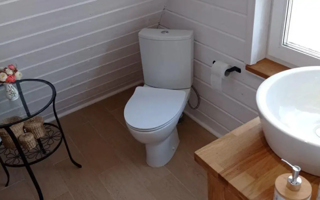 A-frame house with a bath tub and a wood-burning sauna
