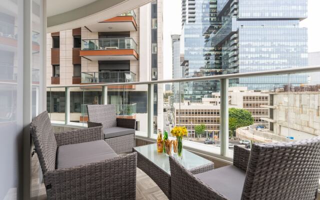 Sunlit Urban Escape with Balcony by Sea N Rent
