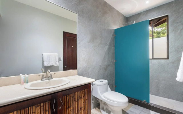 Modern Island-Themed Condo with Floor-to-Ceiling Windows & Garden and Pool Views Within Walking Distance of the Beach