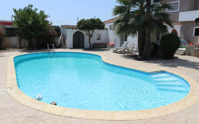 Mediterranean poolside garden cottage