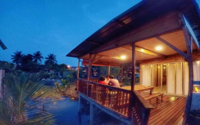 Tung's Tropika - With a Wooden Hut by a Lake