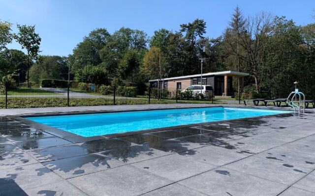 Comfy chalet with a dishwasher, directly on a pond