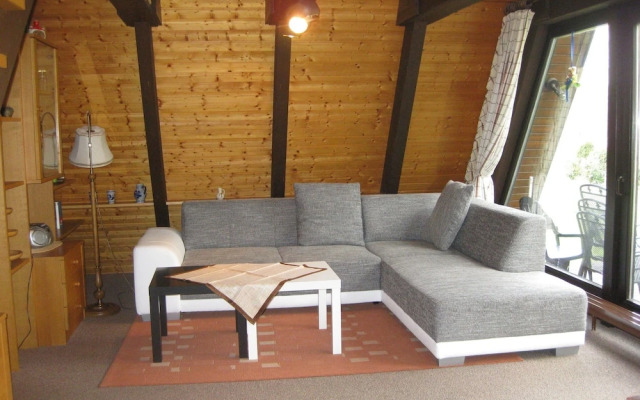 Detached, wooden bungalow with a terrace, in a wooded area