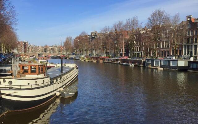 Top apartment along canal in historic centre