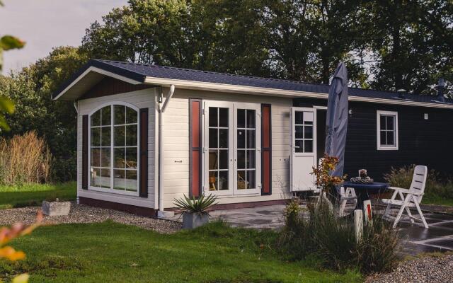 Comfy chalet with a dishwasher, directly on a pond