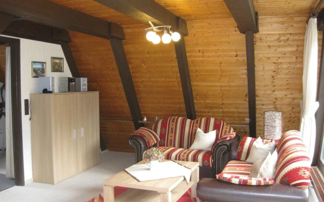 Detached, wooden bungalow with a terrace, in a wooded area