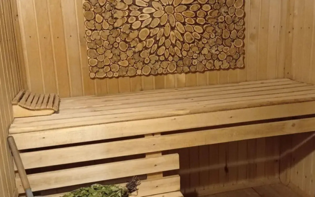 A-frame house with a bath tub and a wood-burning sauna