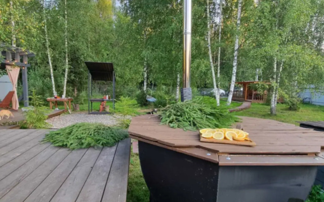 A-frame house with a bath tub and a wood-burning sauna