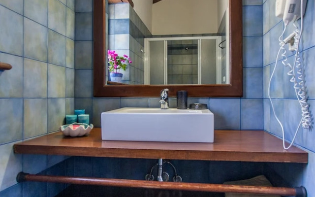 Dine on the Generous Veranda at a Rustic Stone Getaway