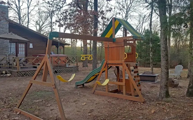 Cast Away Family Cabin with Hot Tub, Fireplace, and Kids Area by RedAwning