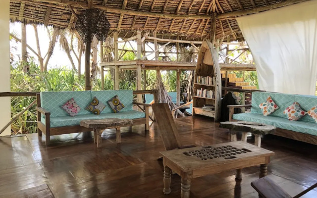 Saadani Safari Lodge - bush, river, beach