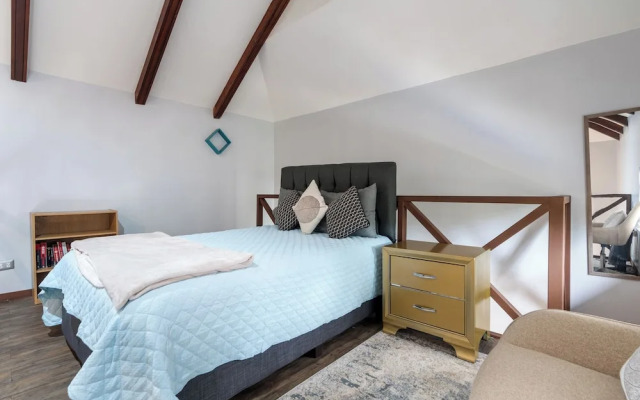 Modern Island-Themed Condo with Floor-to-Ceiling Windows & Garden and Pool Views Within Walking Distance of the Beach