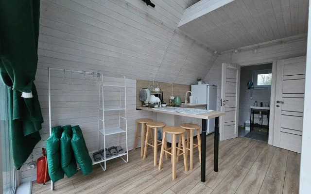 A-Frame house with a vat by the river