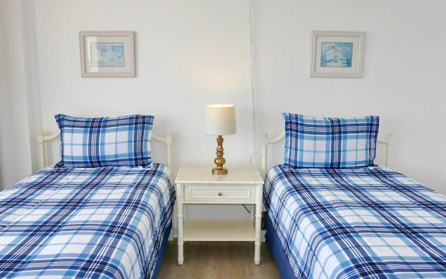 Inviting Beachfront Condo With Large Balcony and Pool