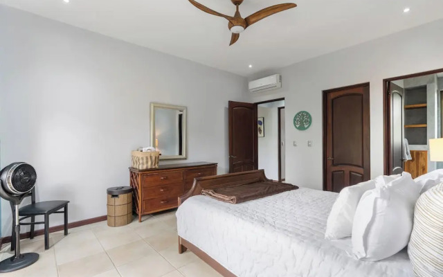 Modern Island-Themed Condo with Floor-to-Ceiling Windows & Garden and Pool Views Within Walking Distance of the Beach