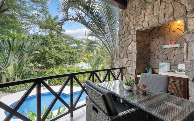 Modern Island-Themed Condo with Floor-to-Ceiling Windows & Garden and Pool Views Within Walking Distance of the Beach